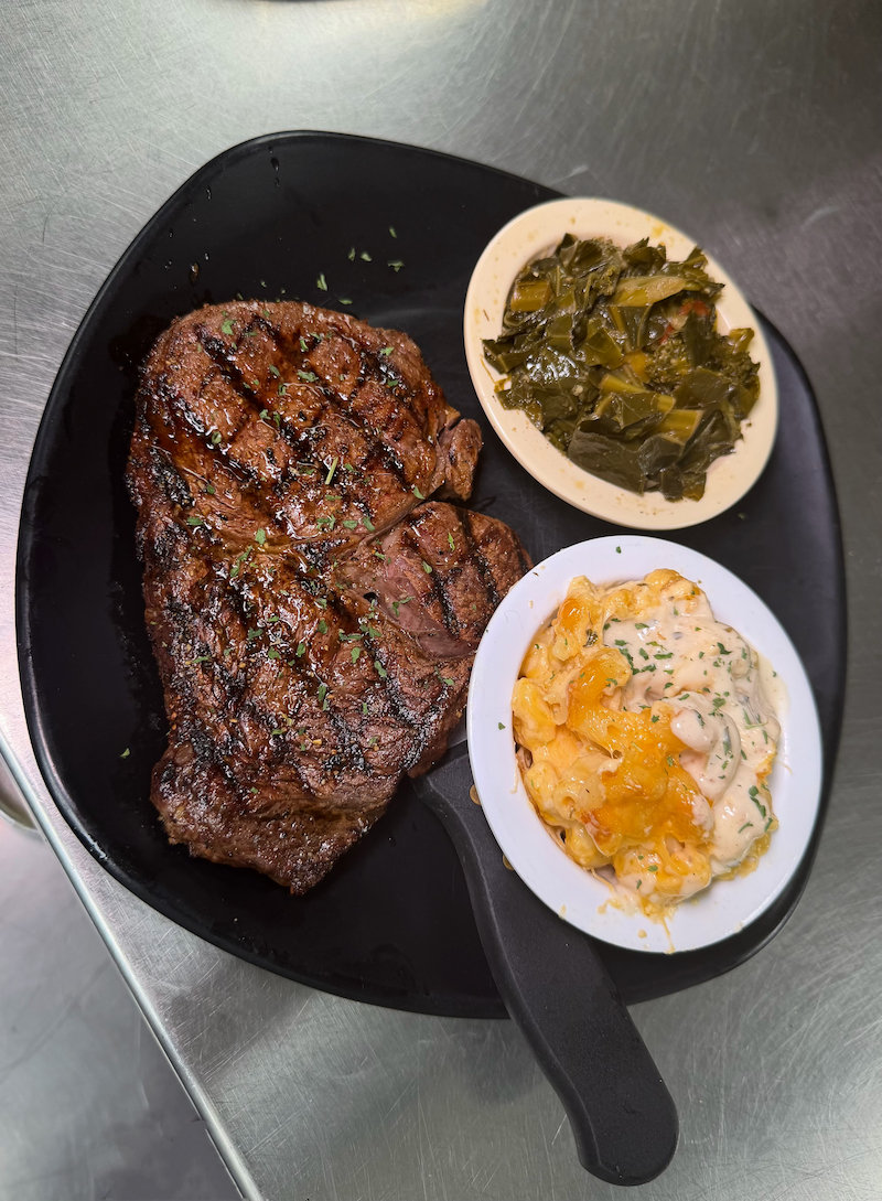Grilled steak with mac and cheese and collard greens
